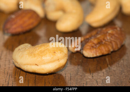 Assorted nuts on dark wooden table Stock Photo