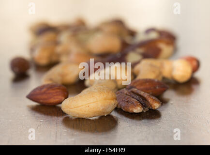 Mixed nuts on a rustic wooden table Stock Photo