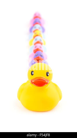 Big rubber duck in front of a line of small ducklings - concept of leading