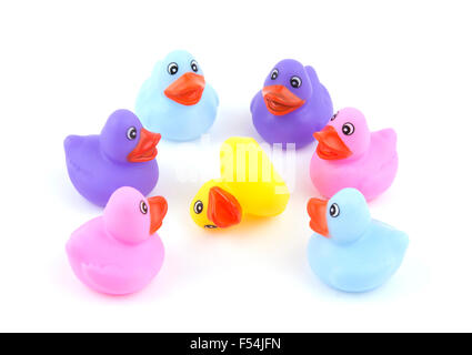Rubber ducks in a circle with one down on white - concept of bullying Stock Photo
