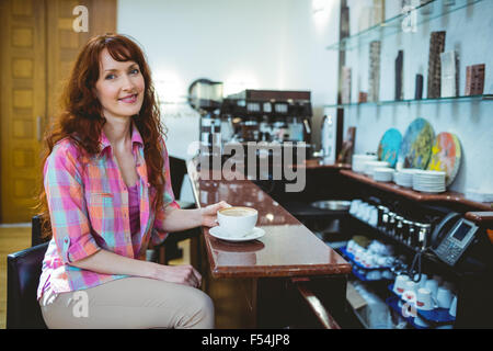 Mature student smiling in cafe Stock Photo