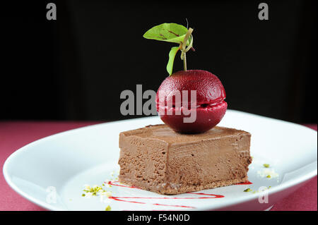 Gourmet chocolate mouse ice cream dessert with a dark cherry sorbet. Stock Photo