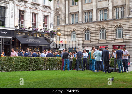 People drinking outside The Globe pub in London England United Kingdom UK Stock Photo