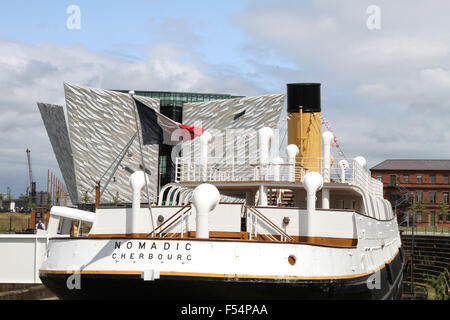 The SS Nomadic in Hamilton Dock, Belfast with The Titanic Visitors' Centre in the background. Stock Photo