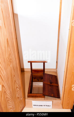 Japan, Tsuyama castle. A faithful reconstruction in the Bitchu Yagura turret of the daimyo's residence. Small room containing toilet with cover. Stock Photo