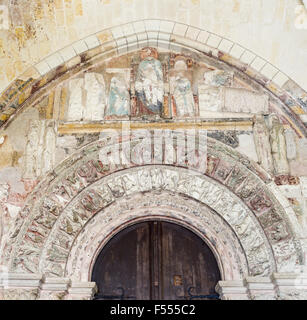 Reliefs over the porch door. Over the entrance to the Collegiate Church of Loches are coloured reliefs in in rough condition. Stock Photo