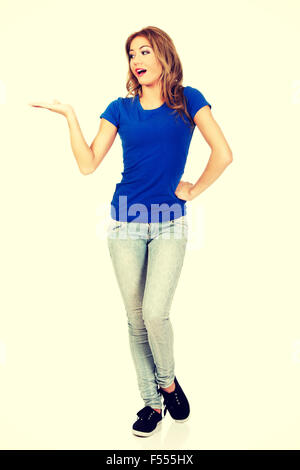 Young woman presenting a product. Stock Photo