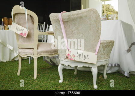 DIY chairs for bride and groom with hand written signs Stock Photo