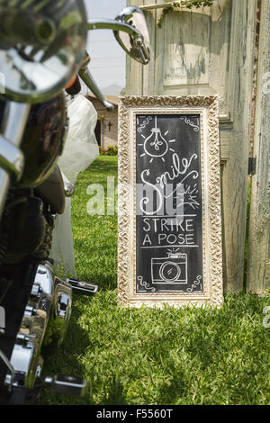 DIY wedding hand written sign on the grass and church in the background Stock Photo