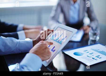 Businessman pointing at touchscreen with chart Stock Photo