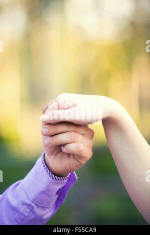 man holding the hand of the beloved Stock Photo