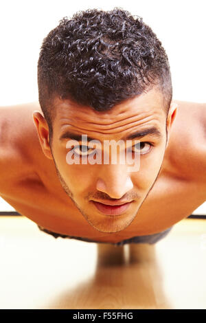 Healthy man doing pushups on the floor Stock Photo