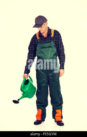 Workman pouring water from watering can Stock Photo