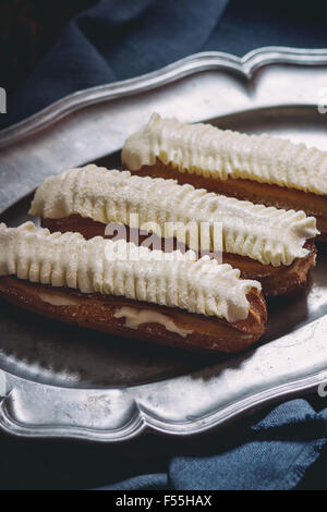 Eclairs in metal plate Stock Photo