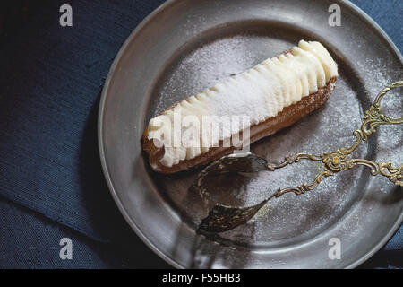 Eclair in metal plate Stock Photo