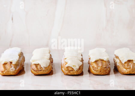 Eclairs on white marble Stock Photo