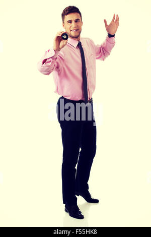 Young businessman holding billiard ball. Stock Photo