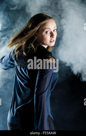 Scared young woman running away looking over shoulder Stock Photo - Alamy