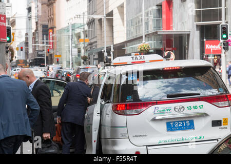 australian taxi in george street Sydney with business men departing having paid their fare,Sydney,Australia Stock Photo