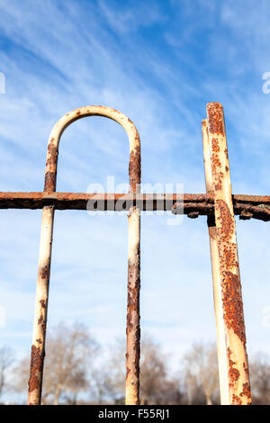 Old rusting metal railing with flaking white paint, England, UK Stock Photo