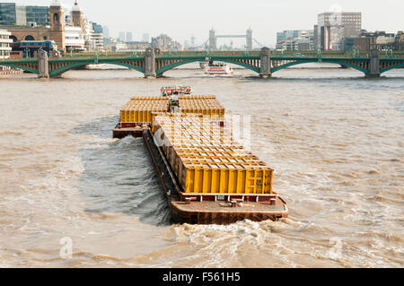 The Cory Riverside tug Reclaim towing containerised rubbish on barges down the Thames. Stock Photo