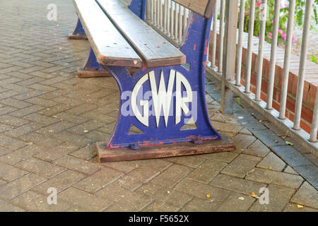 Wooden bench with Great Western Railway logo on platform at Newton Abbot railway station, Devon, England Stock Photo