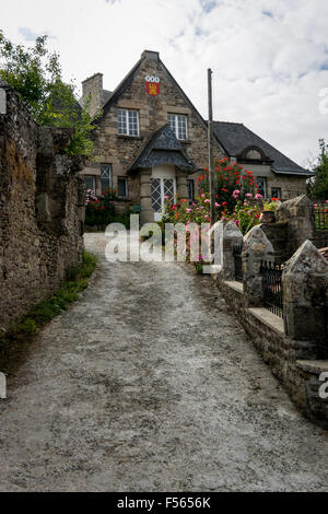 Looking up the driveway towards an old stone cottage in the medieval city of Dinan, Brittany, France Stock Photo