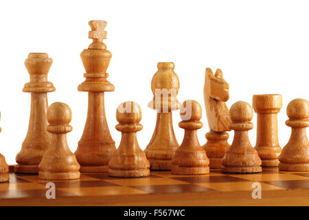 old wooden chess set on a chessboard Stock Photo