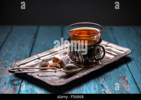 Tea in a glass with a cup holder on metal tray Stock Photo