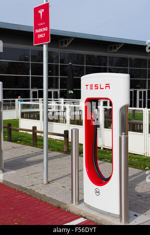 Tesla Supercharger electric car charging station at M42 motorway services Welcome Break Hopwood Park Stock Photo