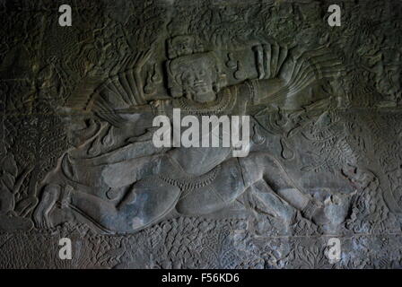 Ancient Khmer bas relief wall carving showing Hindu god with many arms. Angkor Wat Temple, Siem Reap, Cambodia. Stock Photo