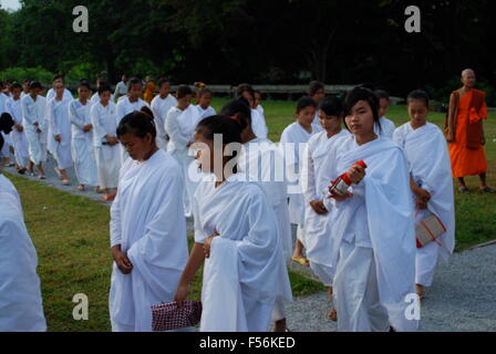 Line of female Buddhist monks walk past Angkor Wat complex. Angkor Wat was first a Hindu, then subsequently, a Buddhist complex. Stock Photo