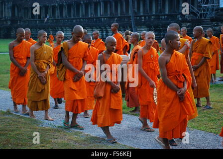 Line of Buddhist monks walk past Angkor Wat complex. Angkor Wat was first a Hindu, then subsequently, a Buddhist temple complex. Stock Photo