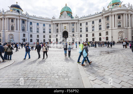 VIENNA, AUSTRIA - SEPTEMBER 27, 2015: tourists on Michaelerplatz square near St. Michael wing Hofburg Palace. Michaelertrakt was Stock Photo