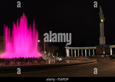 travel to Vienna city - pink illuminated Hochstrahlbrunnen fountain and Soviet War Memorial on Schwarzenbergplatz square, Vienna Stock Photo
