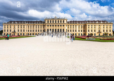 VIENNA, AUSTRIA - SEPTEMBER 29, 2015: tourists and front view of Schloss Schonbrunn palace. Schonbrunn Palace is former imperial Stock Photo