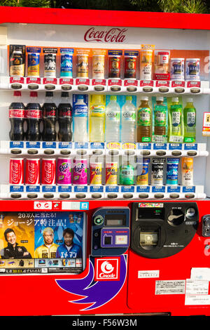 Japanese soft drinks vending maschine serving hot and cold canned drinks including coca-cola, coffees and teas, button colour coded, red equals hot. Stock Photo