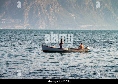 A lone boat on the horizon of the lake Garda in the northern Italy, Gargnano, Italy Stock Photo