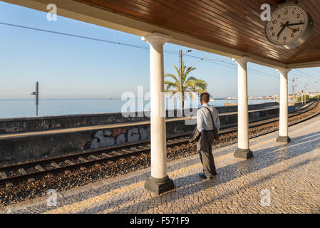 businessmen standing on train platform outdoors, monte estoril, Portugal Stock Photo