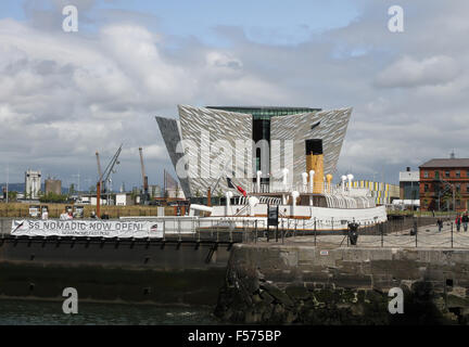 The SS Nomadic in Hamilton Dock, Belfast with The Titanic Visitors' Centre in the background. Stock Photo