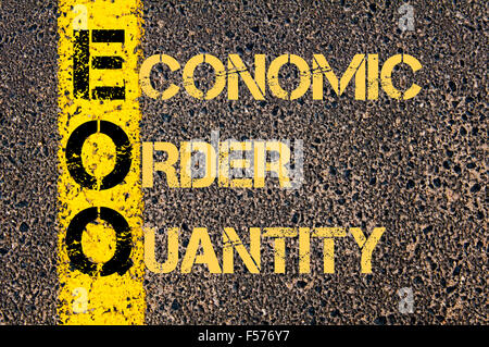 Concept image of Business Acronym EOQ as ECONOMIC ORDER QUANTITY written over road marking yellow paint line. Stock Photo