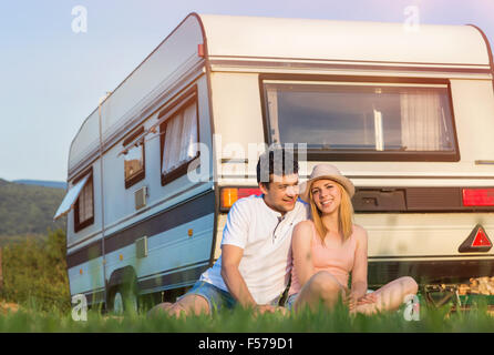 Young couple in front of a camper van Stock Photo