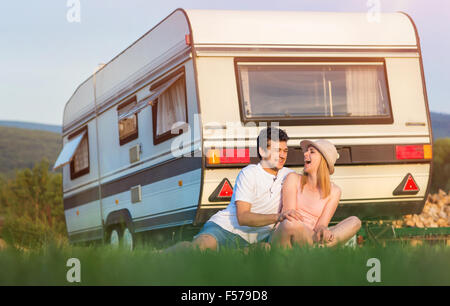 Young couple in front of a camper van Stock Photo