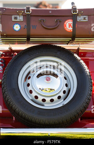 Vintage MG Spare wheel and suitcase on the rear of the car. Classic british sports car Stock Photo