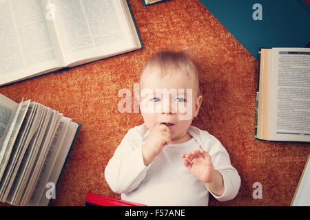 One year old baby with books Stock Photo