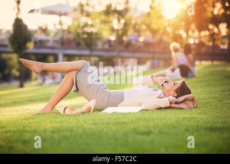 Business woman sitting in a park Stock Photo