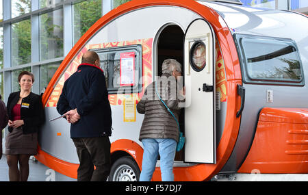 Visitors look at a small trailer at the 'Travel & Caravan' tourism trade fair in Erfurt, Germany, 29 October 2015. According to the organizers, around 270 exhibitors are offering travel destinations all over the world. Interested people can also get an overview of the caravan market. Nearly 30 brands of leading manufacturers are present. Photo: MARTIN SCHUTT/dpa Stock Photo