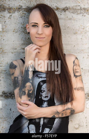 Young woman with tattoos, smiling, portrait Stock Photo