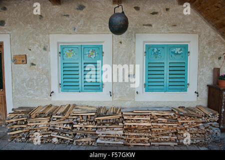 Windows and logs on an old house in Colle Santa Lucia in the Dolomites, Italy Stock Photo