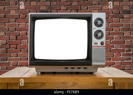 Vintage portable television with red brick wall and cut out screen. Stock Photo